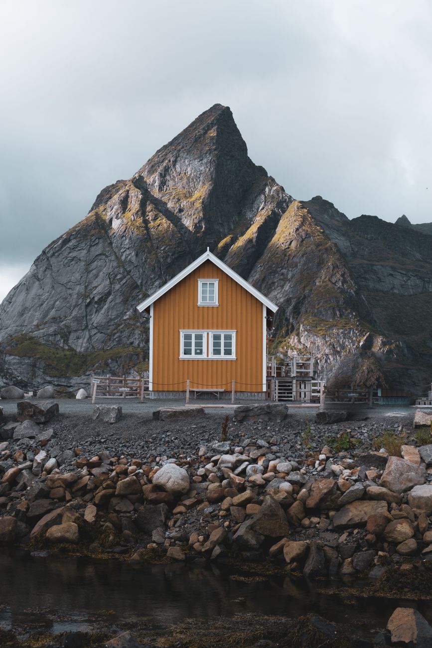 Norwegian fjord with solitary wooden cabin